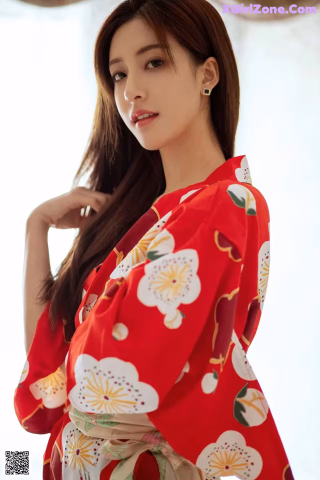 a woman in a red kimono posing for a picture