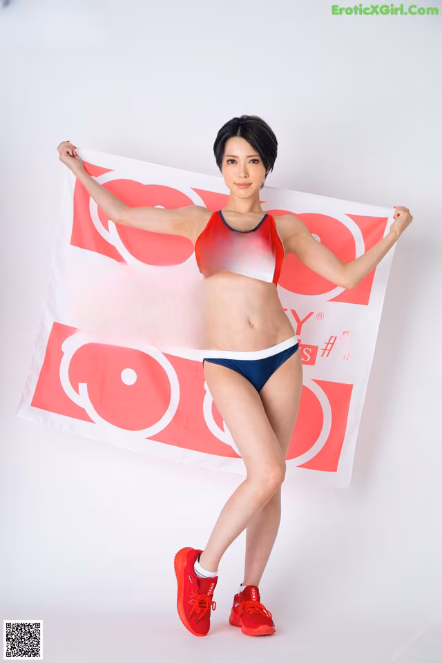 A woman in a bikini holding up a banner.
