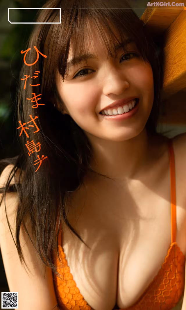 A woman in an orange bikini posing for a picture.