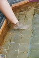 A woman's bare feet in a pool of water.