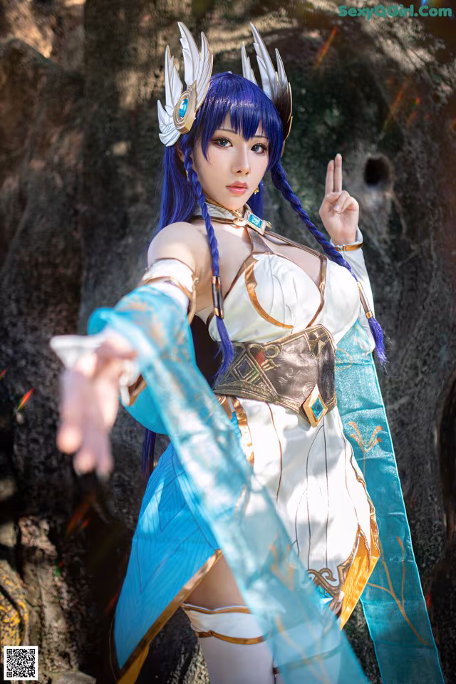 A woman dressed in a blue and white outfit holding a sword.