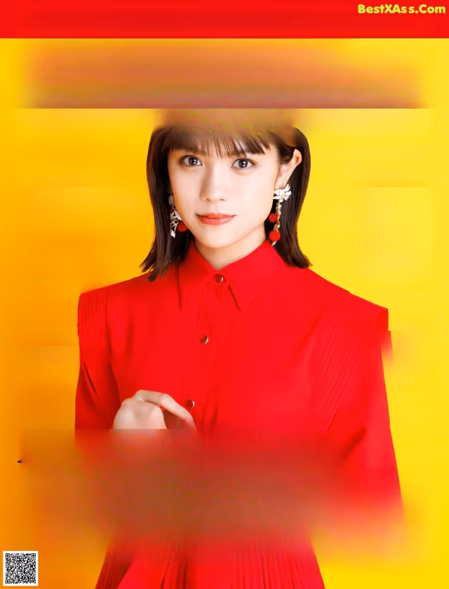 A woman in a red shirt is on the cover of a magazine.